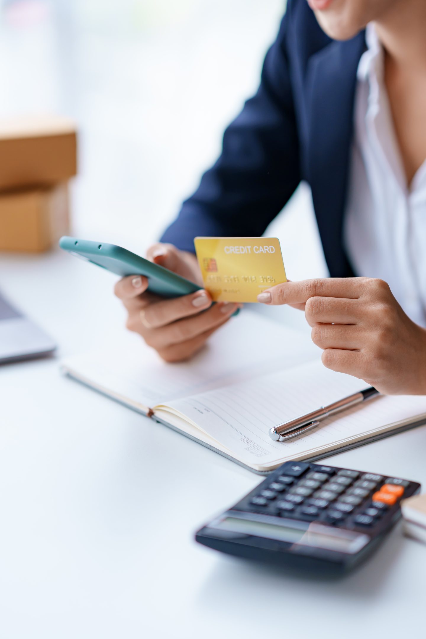 Young woman using a credit card through a smartphone application for online shopping and online payments